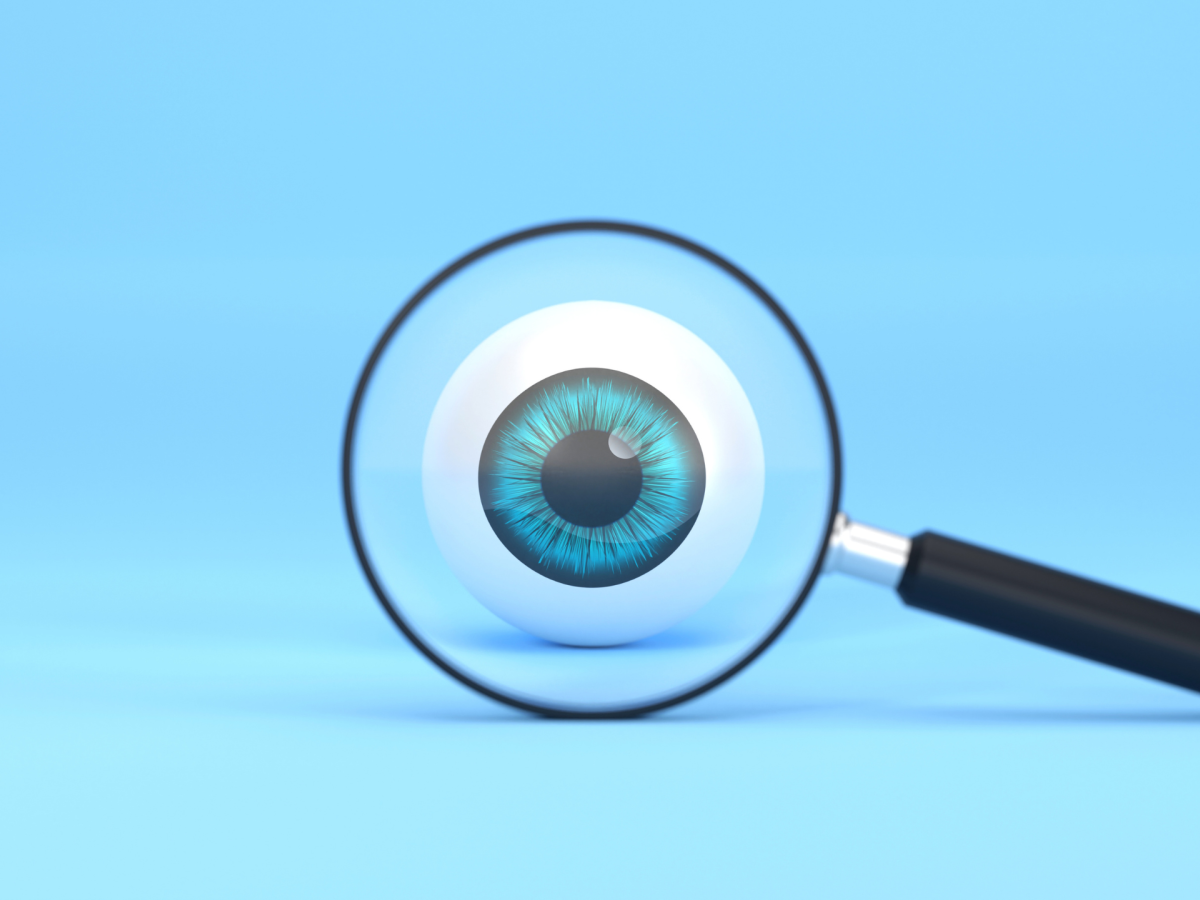 Blue background with a magnifying glass looking at a cartoon eyeball.